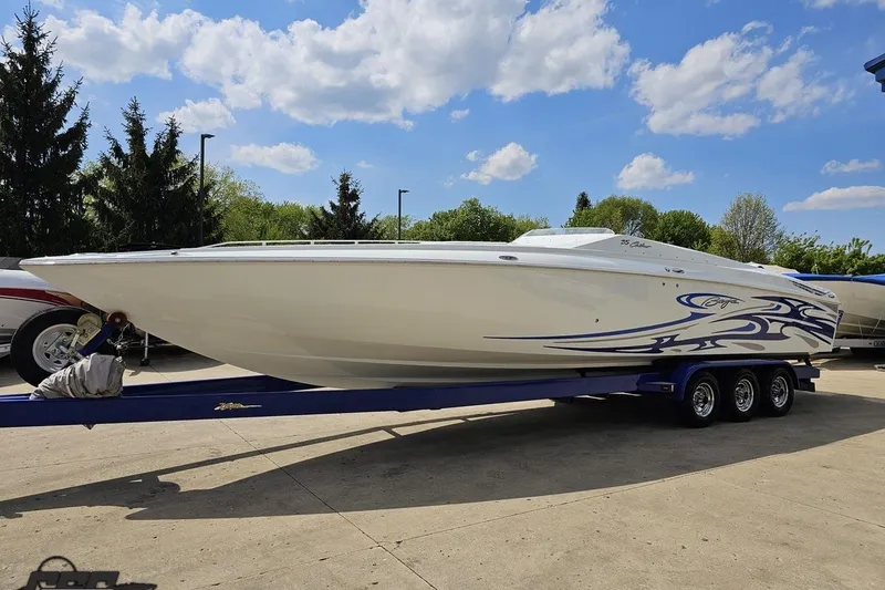 Slide: The Image of 2006 Baja 35 Outlaw speedboat on trailer under blue sky. - 17