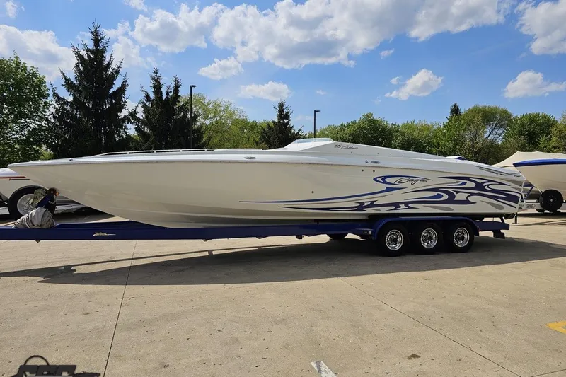 Slide: The Image of 2006 Baja 35 Outlaw speedboat on trailer, featuring sleek design and blue graphics. - 18