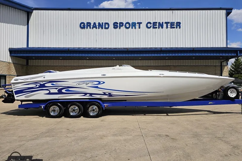 Slide: The Image of 2006 Baja 35 Outlaw boat with blue graphics at Grand Sport Center. - 2