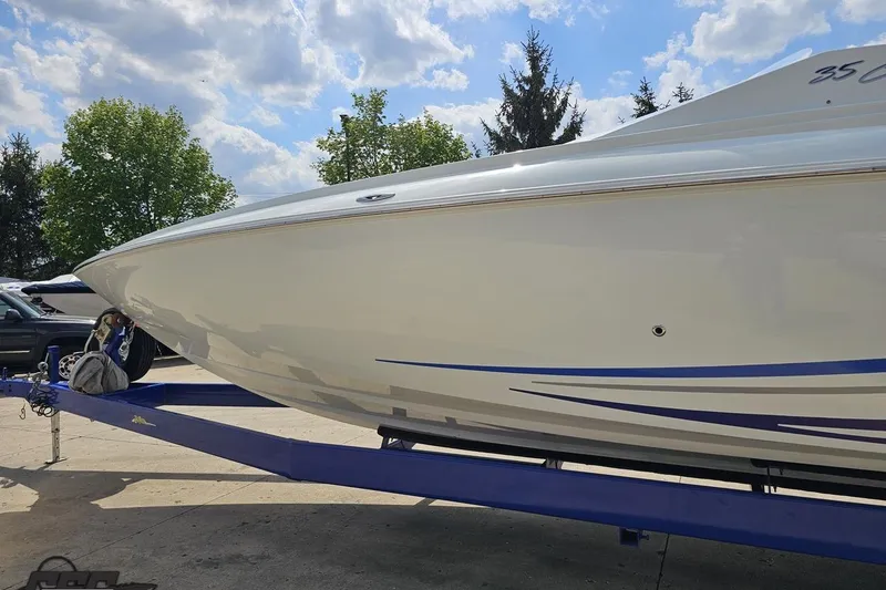 Slide: The Image of 2006 Baja 35 Outlaw boat on trailer under a partly cloudy sky. - 20