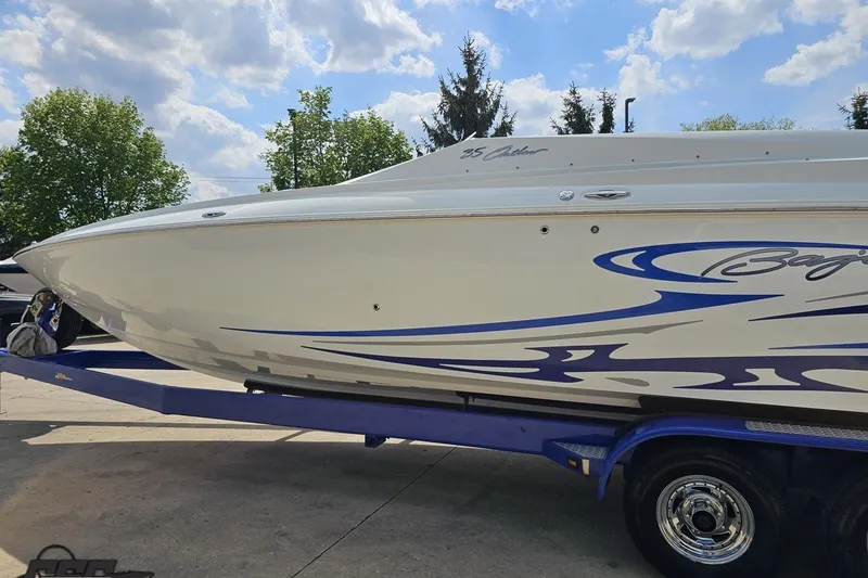 Slide: The Image of 2006 Baja 35 Outlaw speedboat on trailer under a partly cloudy sky. - 21