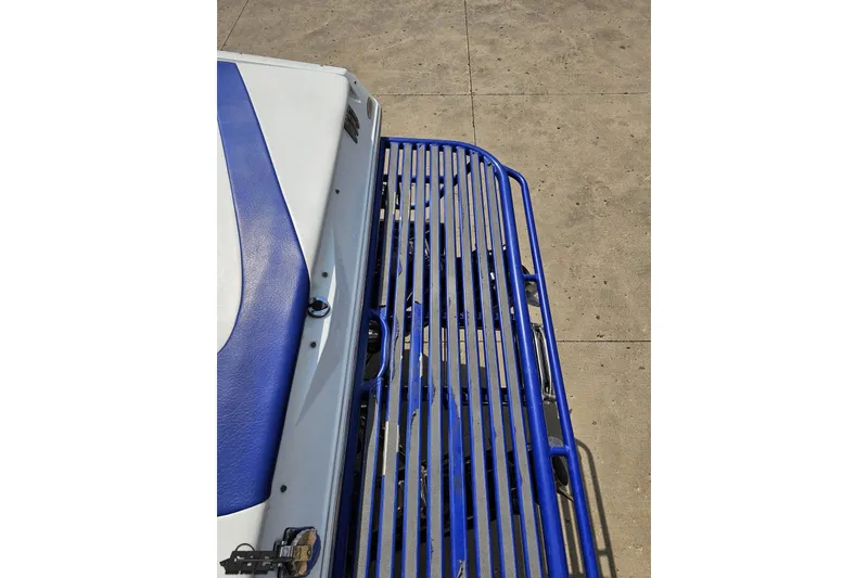 Slide: The Image of 2006 Baja 35 Outlaw boat with blue and white seating and metal railing. - 28