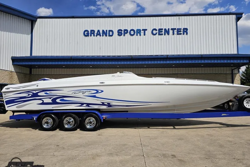 Slide: The Image of 2006 Baja 35 Outlaw boat with blue graphics at Grand Sport Center. - 3