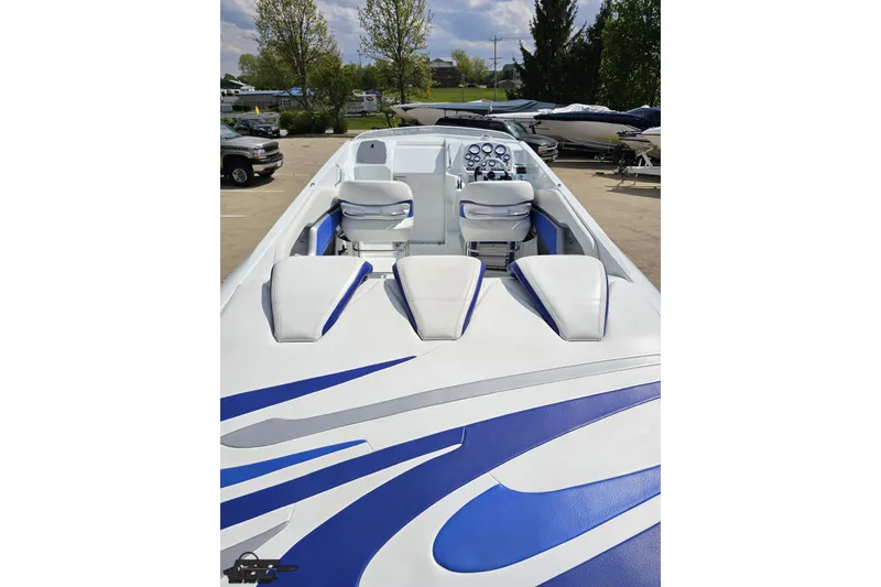 Slide: The Image of 2006 Baja 35 Outlaw boat with sleek white and blue design, featuring comfortable seating. - 31