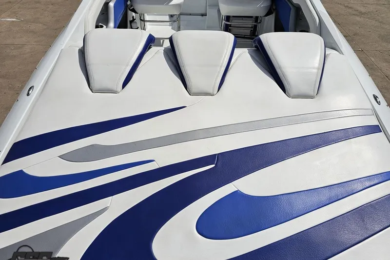 Slide: The Image of 2006 Baja 35 Outlaw boat with blue and white upholstery design. - 32