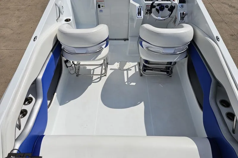 Slide: The Image of Interior of a 2006 Baja 35 Outlaw boat with white and blue seating. - 37