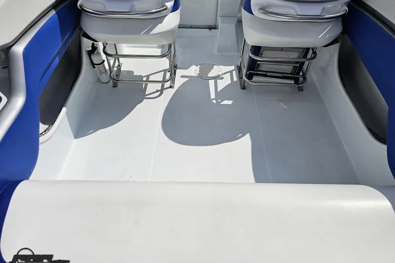 Slide: The Image of 2006 Baja 35 Outlaw boat interior with blue and white seating. - 38