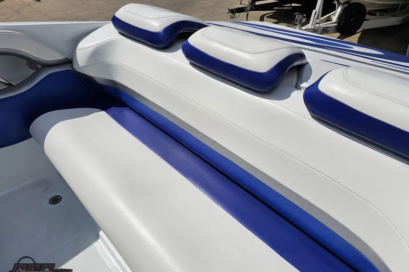 Slide: The Image of 2006 Baja 35 Outlaw boat interior with white and blue cushioned seating. - 39