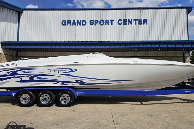 Slide: The Image of 2006 Baja 35 Outlaw boat with blue graphics at Grand Sport Center. - 4