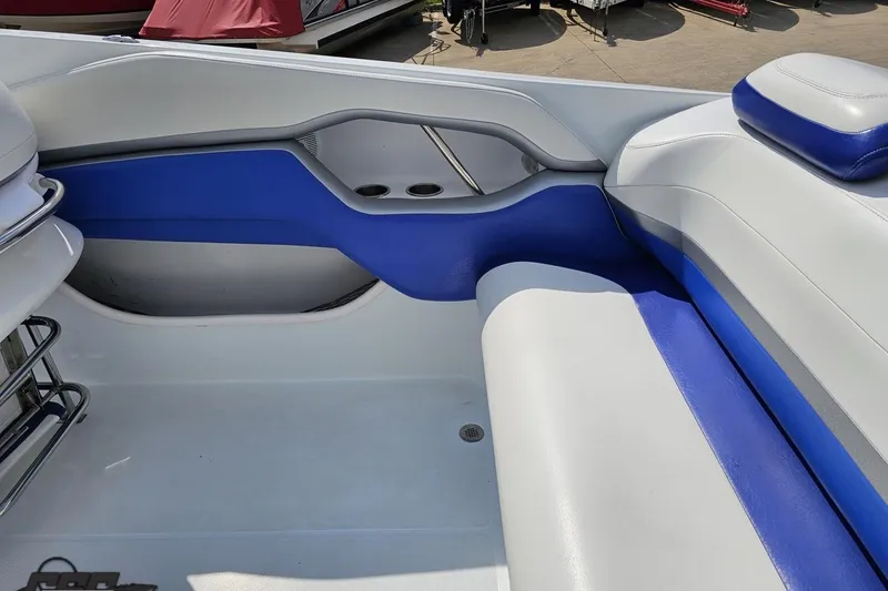 Slide: The Image of Interior of a 2006 Baja 35 Outlaw boat with blue and white seating. - 40
