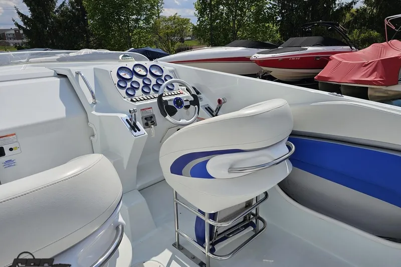 Slide: The Image of Interior of a 2006 Baja 35 Outlaw boat with white and blue seating. - 41