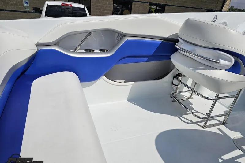 Slide: The Image of 2006 Baja 35 Outlaw boat interior with blue and white seating and cup holders. - 42