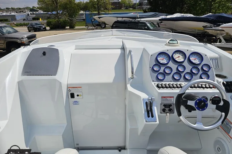Slide: The Image of 2006 Baja 35 Outlaw boat dashboard with gauges and steering wheel. - 45