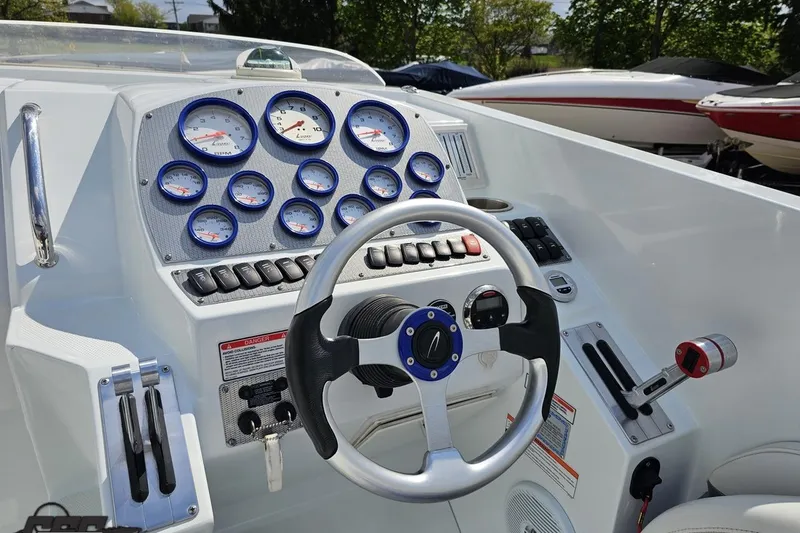 Slide: The Image of 2006 Baja 35 Outlaw boat dashboard with steering wheel and gauges. - 47