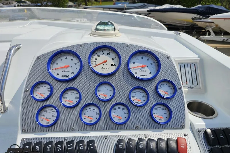 Slide: The Image of Dashboard of a 2006 Baja 35 Outlaw boat with multiple gauges and controls. - 49