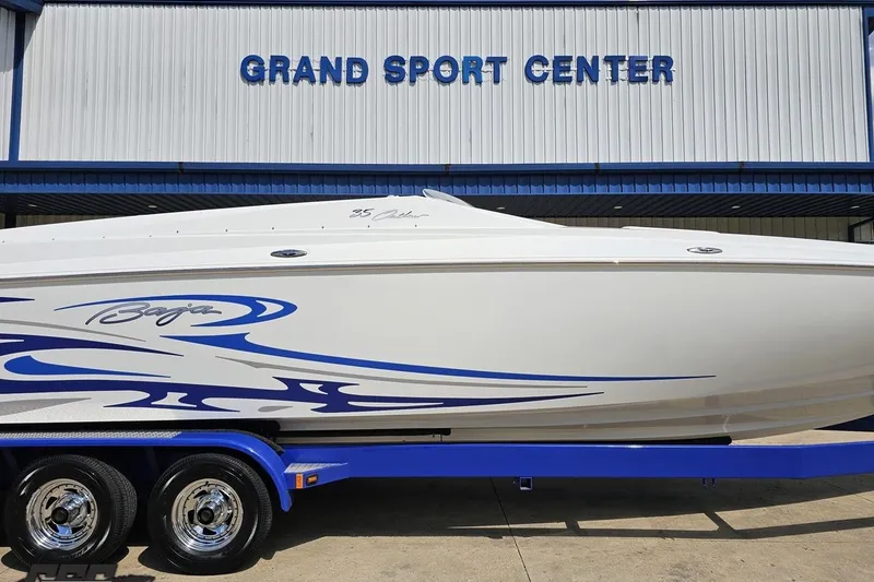 Slide: The Image of 2006 Baja 35 Outlaw boat with blue graphics at Grand Sport Center. - 5