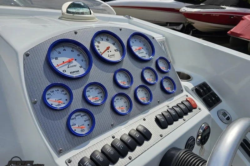 Slide: The Image of Dashboard of a 2006 Baja 35 Outlaw boat with Livorsi gauges and controls. - 50
