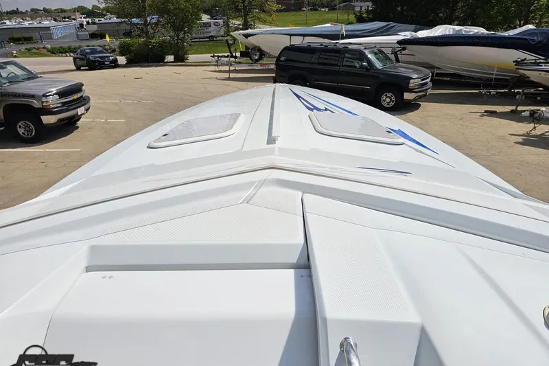 Slide: The Image of 2006 Baja 35 Outlaw boat on trailer, viewed from the bow in a parking lot. - 52