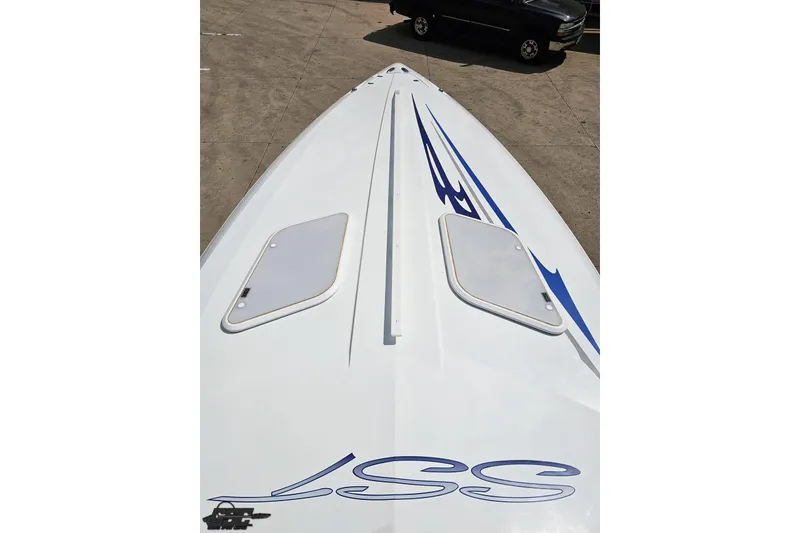 Slide: The Image of 2006 Baja 35 Outlaw boat with sleek design and blue graphics on deck. - 53