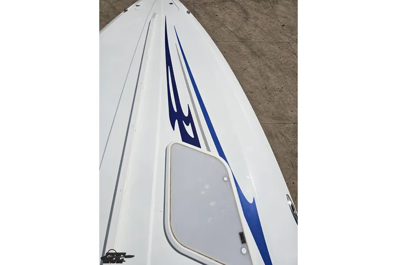 Slide: The Image of 2006 Baja 35 Outlaw boat deck with blue graphics and hatch. - 55