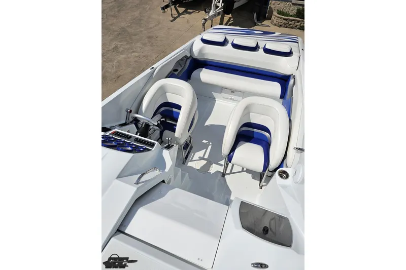 Slide: The Image of 2006 Baja 35 Outlaw boat interior with white and blue seating, sleek design. - 58