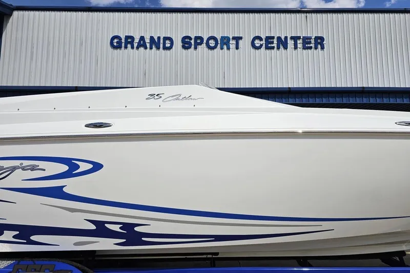Slide: The Image of 2006 Baja 35 Outlaw boat at Grand Sport Center, featuring sleek design and blue graphics. - 6
