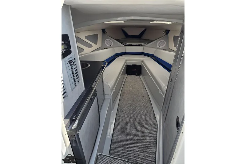 Slide: The Image of Interior of a 2006 Baja 35 Outlaw boat, featuring sleek seating and modern amenities. - 60