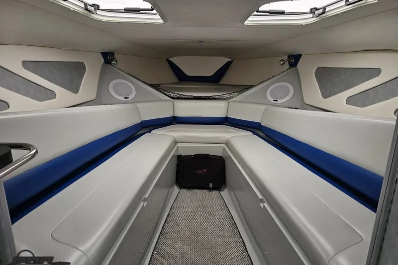 Slide: The Image of Interior of a 2006 Baja 35 Outlaw boat with cushioned seating and speakers. - 63