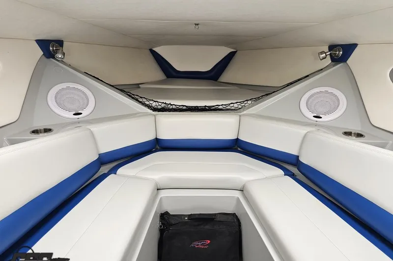 Slide: The Image of Interior of a 2006 Baja 35 Outlaw boat with white and blue seating. - 68
