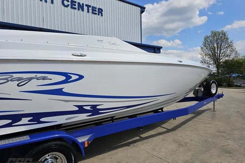 Slide: The Image of 2006 Baja 35 Outlaw boat on trailer, featuring sleek blue graphics. - 9