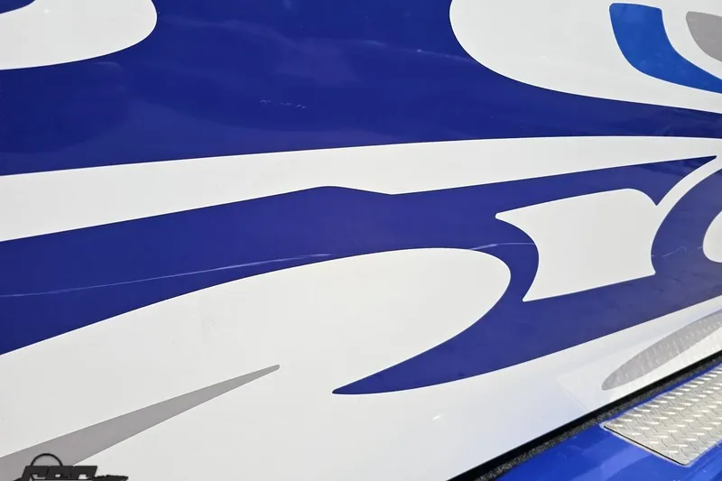Slide: The Image of Close-up of 2006 Baja 35 Outlaw boat with blue and white graphic design. - 92