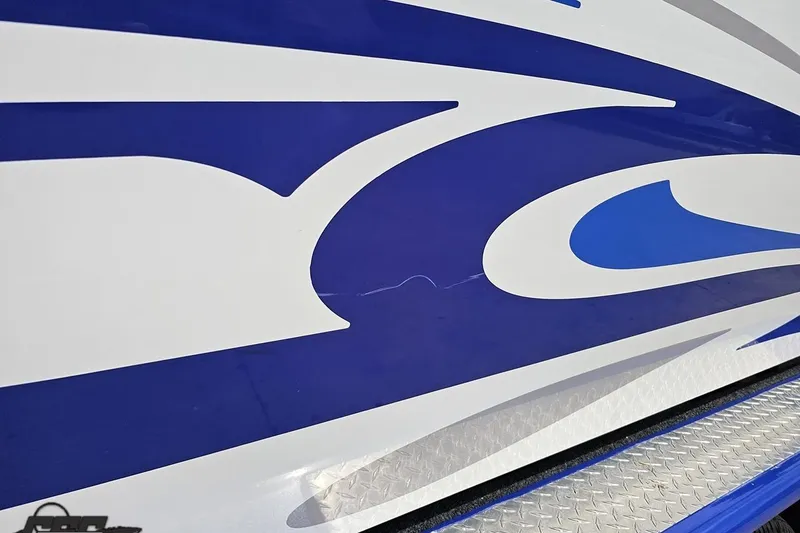 Slide: The Image of Close-up of 2006 Baja 35 Outlaw boat with blue and white graphic design. - 93