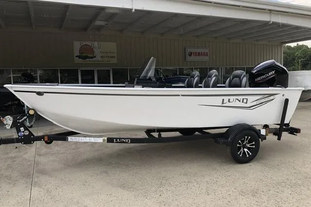 The Image of 2026 Lund 1650 Rebel XL SS boat on trailer, parked outdoors. - 0