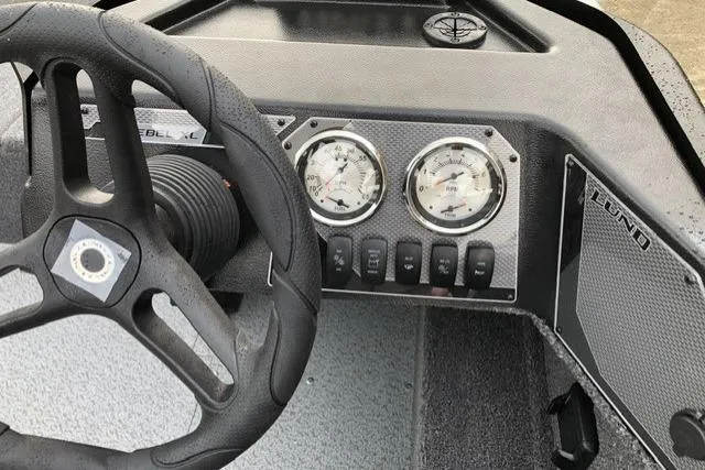 Slide: The Image of 2026 Lund 1650 Rebel XL SS boat dashboard with steering wheel and gauges. - 3