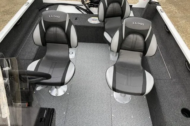 Slide: The Image of 2026 Lund 1650 Rebel XL SS boat interior with three gray seats. - 4