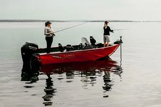 Slide: The Image of Manufacturer Provided Image: 2025 Lund 1650 Rebel XL SS boat with two people fishing on calm water. - 9