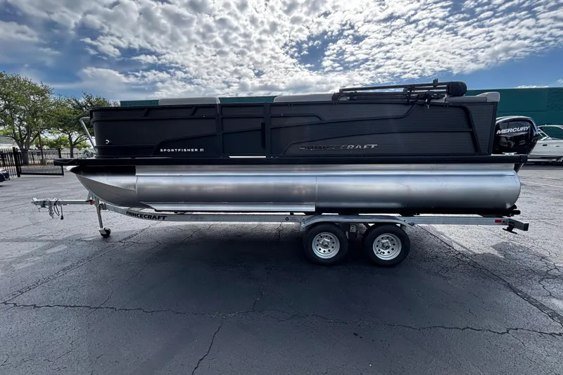 The Image of 2026 Princecraft Sportfisher 21-2S pontoon boat on trailer under cloudy sky. - 1
