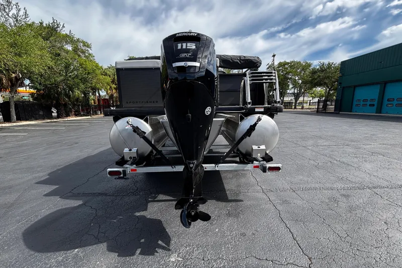 Slide: The Image of 2026 Princecraft Sportfisher 21-2S boat with Mercury 115 engine, parked outdoors. - 4