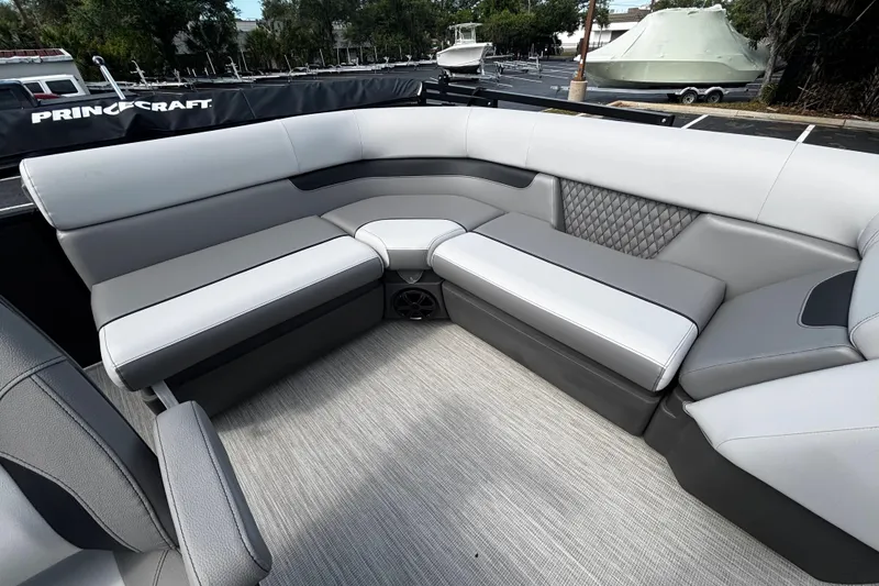 Slide: The Image of 2026 Princecraft Sportfisher 21-2S boat interior with gray cushioned seating. - 7