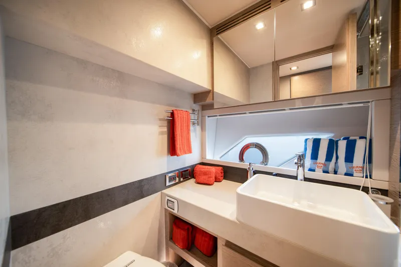 Slide: The Image of Luxurious bathroom interior of 2019 Filippetti S55 yacht with modern sink and vibrant towels. - 29