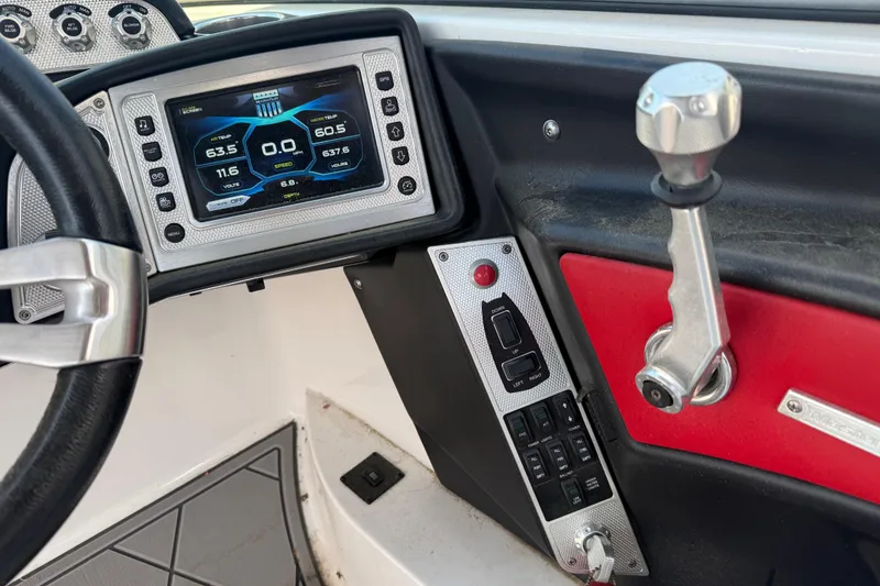 Slide: The Image of 2013 MasterCraft X-45 dashboard with digital display and control panel. - 12