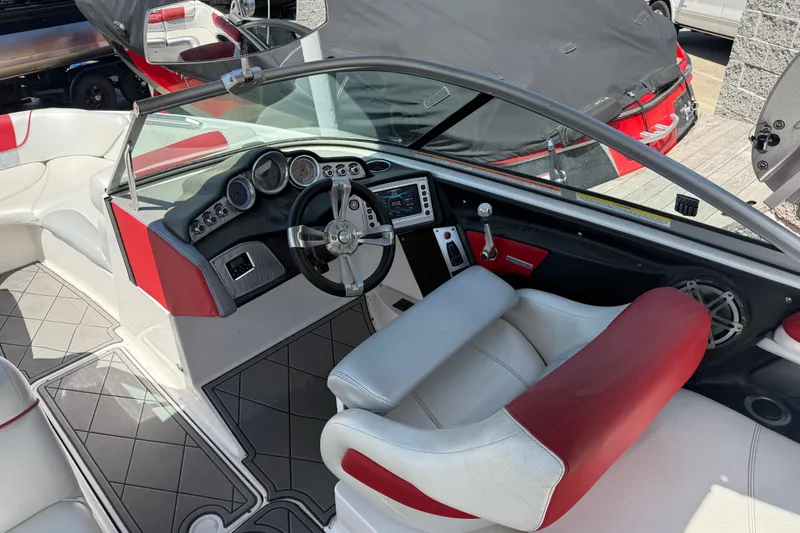 Slide: The Image of Interior of a 2013 MasterCraft X-45 boat with red and white seating. - 13