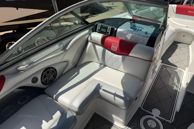 Slide: The Image of 2013 MasterCraft X-45 boat interior with white and red seating, modern dashboard, and stylish flooring. - 14
