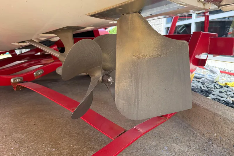 Slide: The Image of Propeller and rudder of 2013 MasterCraft X-45 boat on red trailer. - 24