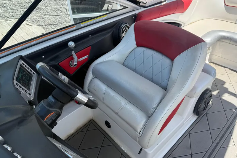 Slide: The Image of 2013 MasterCraft X-45 boat interior with steering wheel and cushioned seat. - 7