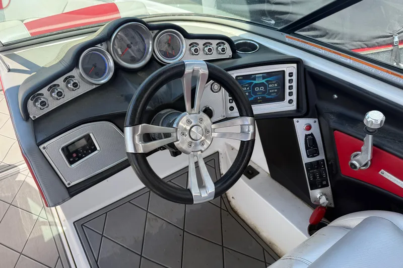 Slide: The Image of 2013 MasterCraft X-45 boat dashboard with steering wheel and control panel. - 8