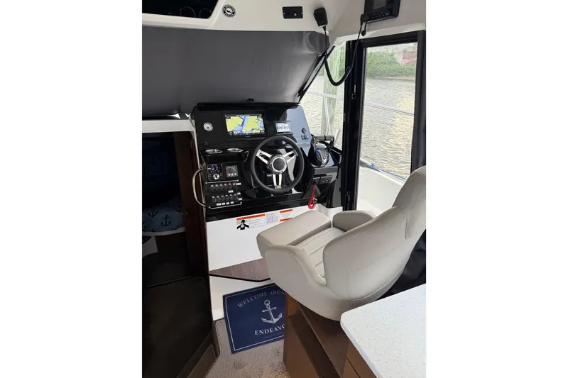Slide: The Image of Interior helm of 2022 Jeanneau NC Weekender 1095 with navigation equipment and captain's chair. - 14