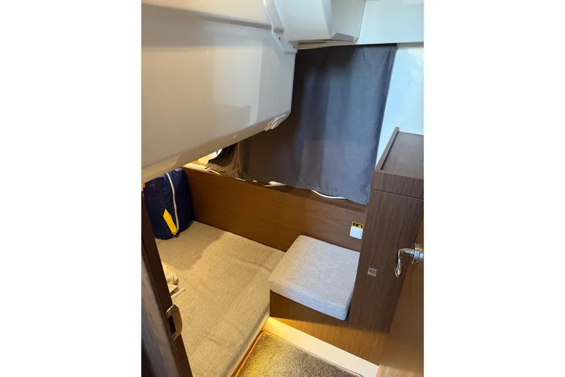 Slide: The Image of Interior cabin of 2022 Jeanneau NC Weekender 1095 with cozy seating and curtain. - 16