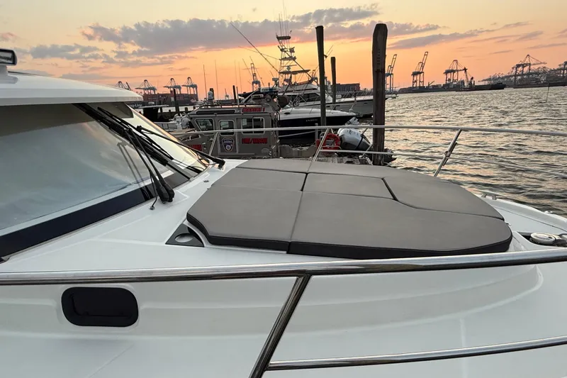 Slide: The Image of 2022 Jeanneau NC Weekender 1095 at sunset, docked with scenic harbor view. - 3