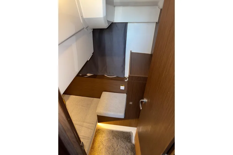 Slide: The Image of Interior cabin of 2022 Jeanneau NC Weekender 1095 with wooden finish and cozy seating. - 8